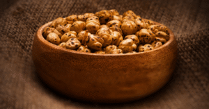 Bowl of crispy roasted chickpeas seasoned with paprika and herbs, perfect for a healthy plant-based snack.